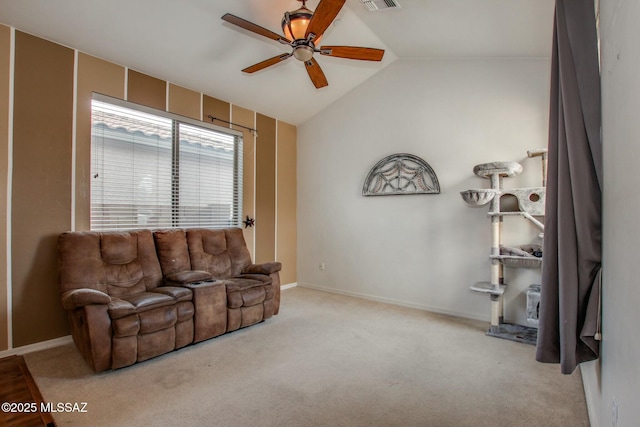 living room with vaulted ceiling, light colored carpet, and ceiling fan