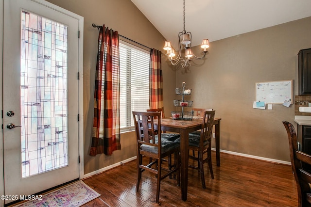 dining room with lofted ceiling, a chandelier, and dark hardwood / wood-style flooring