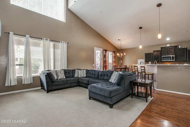 living room featuring a towering ceiling, dark hardwood / wood-style floors, and a notable chandelier