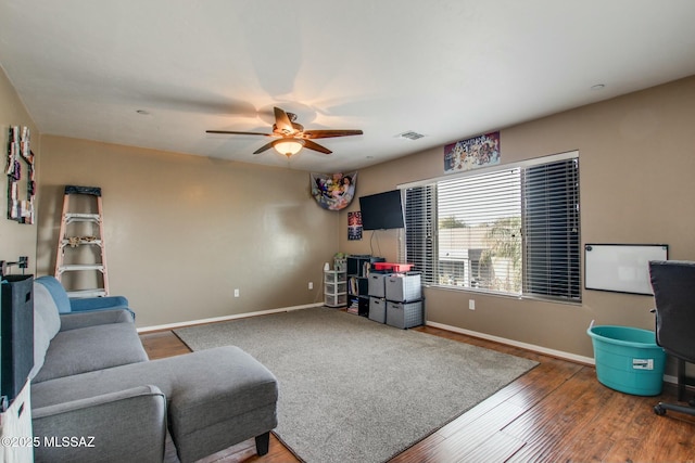 living room with hardwood / wood-style floors and ceiling fan