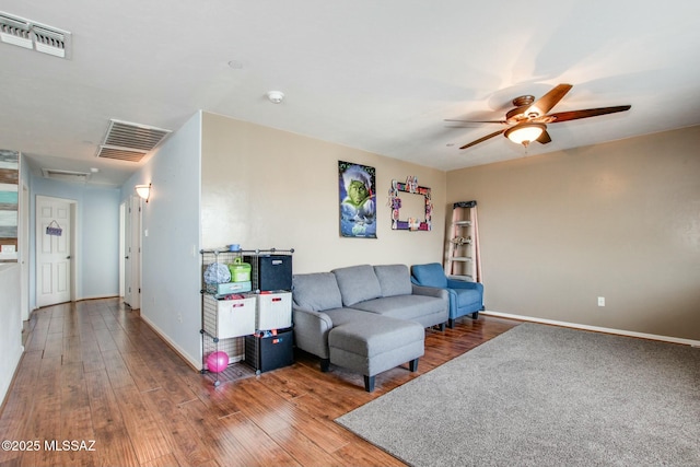 living room featuring wood-type flooring and ceiling fan