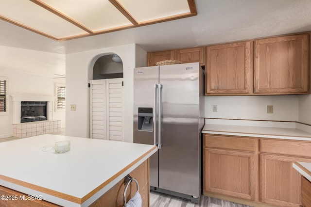 kitchen with a tile fireplace and high end refrigerator