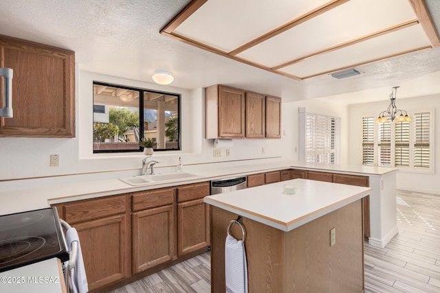 kitchen featuring a notable chandelier, hanging light fixtures, a healthy amount of sunlight, and sink