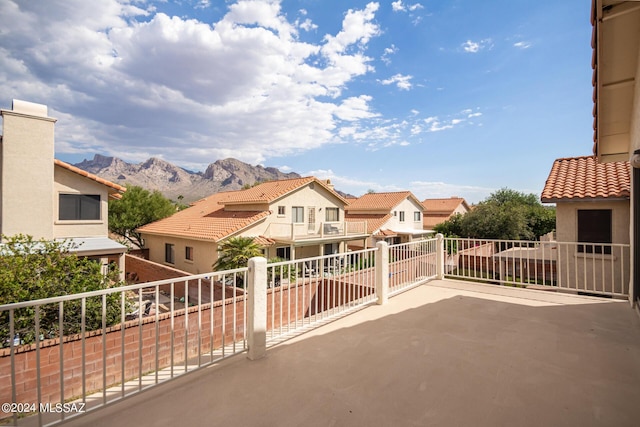 view of patio featuring a mountain view and a balcony