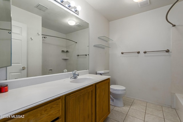 bathroom with tile patterned floors, vanity, and toilet