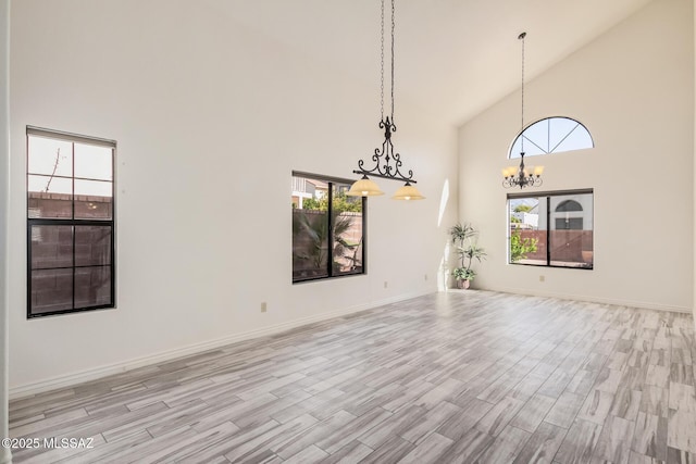 interior space with an inviting chandelier, high vaulted ceiling, and plenty of natural light