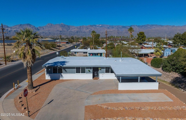 view of front of home with a carport and a mountain view