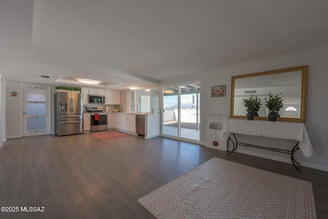 unfurnished living room with dark wood-type flooring