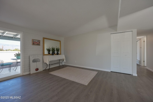 interior space with hardwood / wood-style floors and lofted ceiling