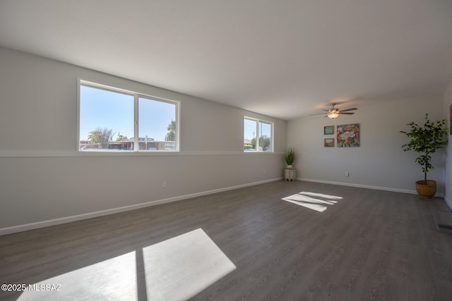 empty room with ceiling fan and dark wood-type flooring