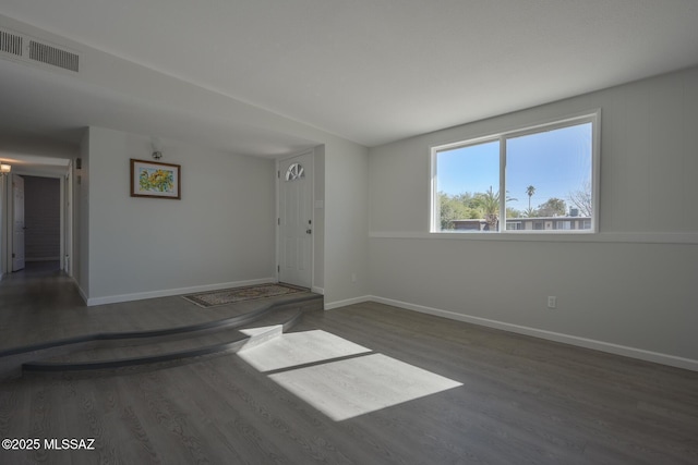 unfurnished room featuring dark hardwood / wood-style floors