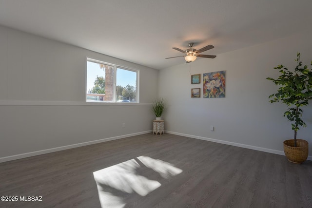 spare room featuring ceiling fan and dark hardwood / wood-style floors