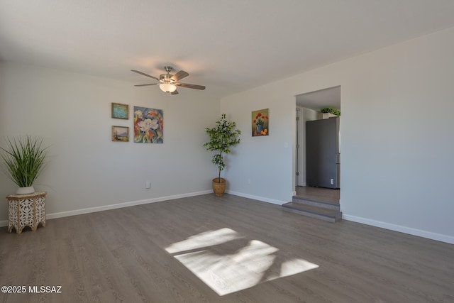 empty room with ceiling fan and hardwood / wood-style floors