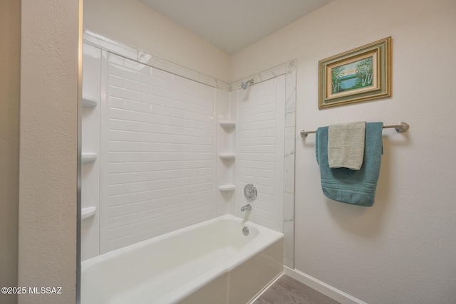 bathroom with hardwood / wood-style flooring and bathtub / shower combination