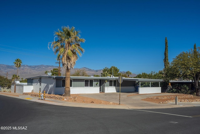 single story home with a carport and a mountain view