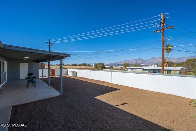 view of yard featuring a patio and a mountain view