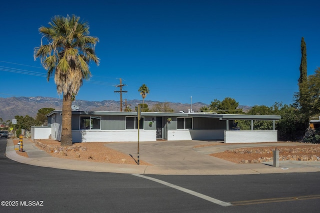 ranch-style home with a carport and a mountain view