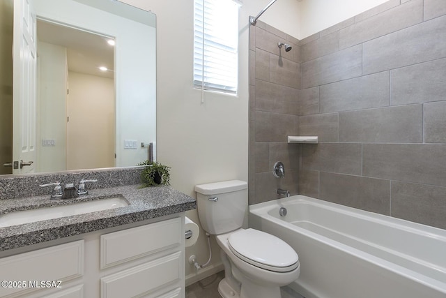 full bathroom featuring toilet, tiled shower / bath, and vanity