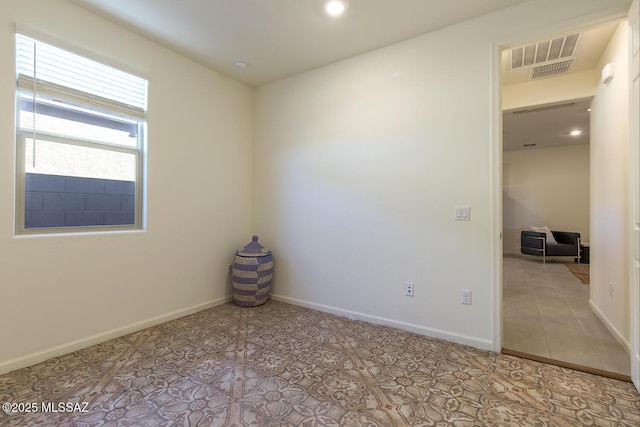 spare room featuring light tile patterned floors