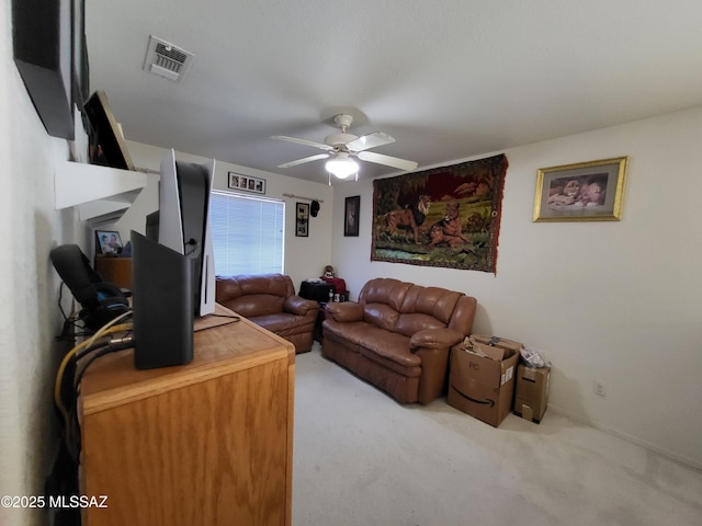 carpeted living room featuring ceiling fan