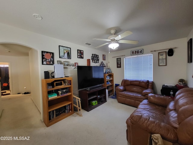 carpeted living room featuring ceiling fan