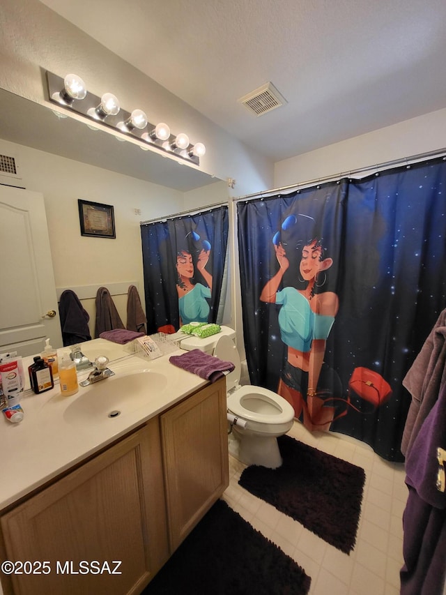 bathroom featuring vanity, toilet, and walk in shower