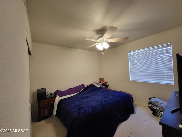 bedroom featuring light carpet and ceiling fan