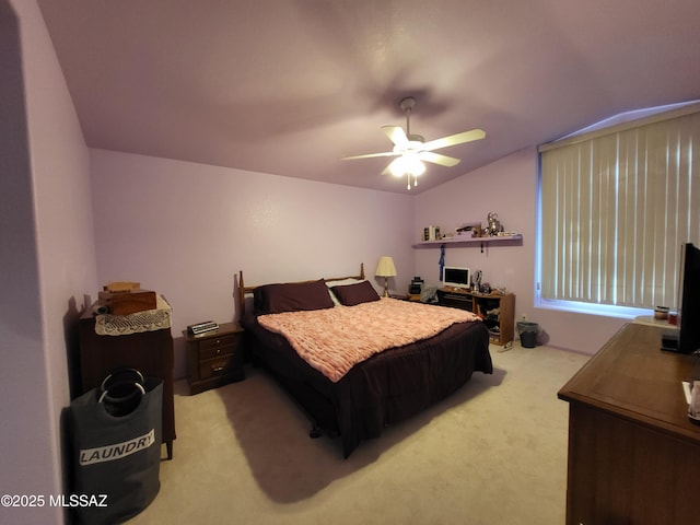 carpeted bedroom with ceiling fan and vaulted ceiling