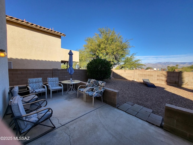 view of patio / terrace with a mountain view