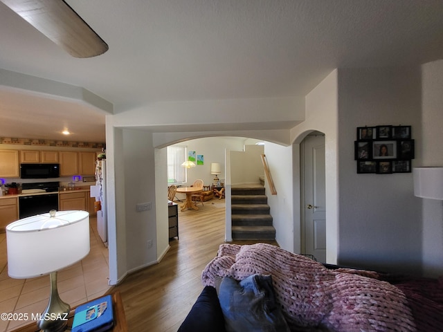 bedroom featuring white fridge and light wood-type flooring