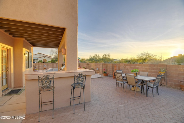 patio terrace at dusk with exterior bar