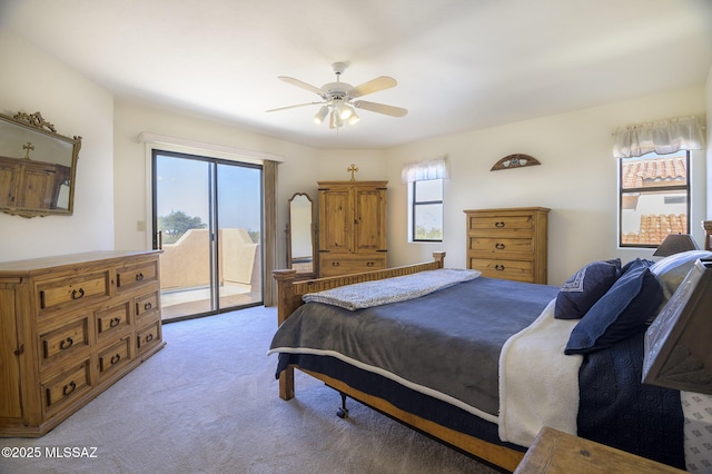 bedroom with light colored carpet, access to exterior, and ceiling fan