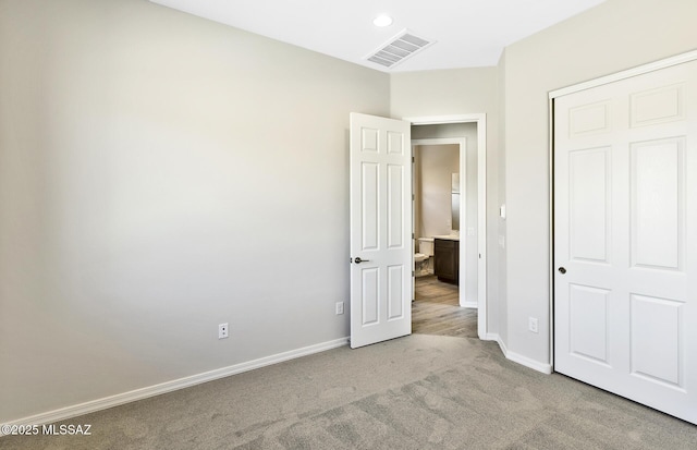 unfurnished bedroom with visible vents, baseboards, and carpet flooring