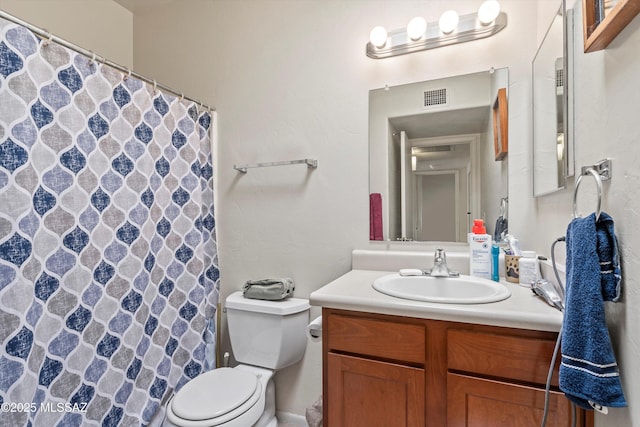 bathroom with toilet and vanity