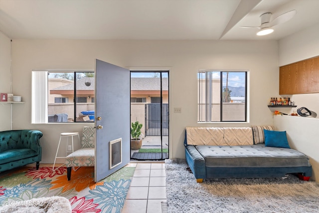 living room featuring ceiling fan and light tile patterned floors