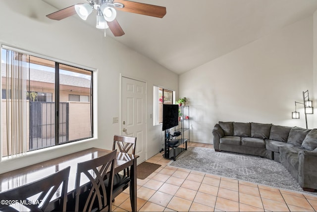 living room with lofted ceiling, ceiling fan, and light tile patterned floors