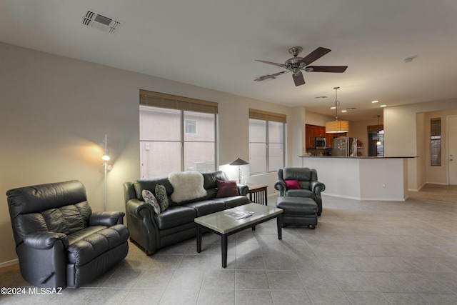 tiled living room with ceiling fan