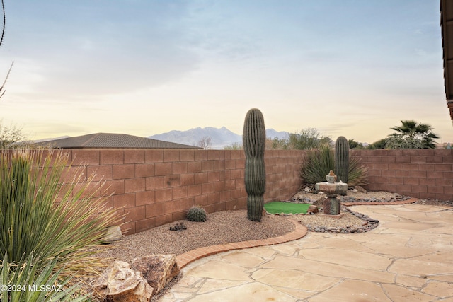 patio terrace at dusk with a mountain view