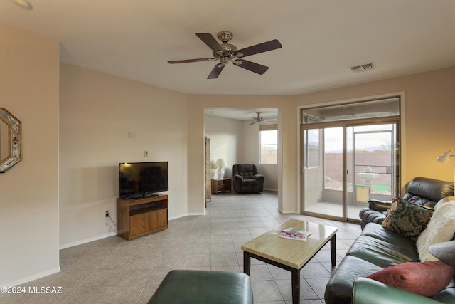 tiled living room featuring ceiling fan