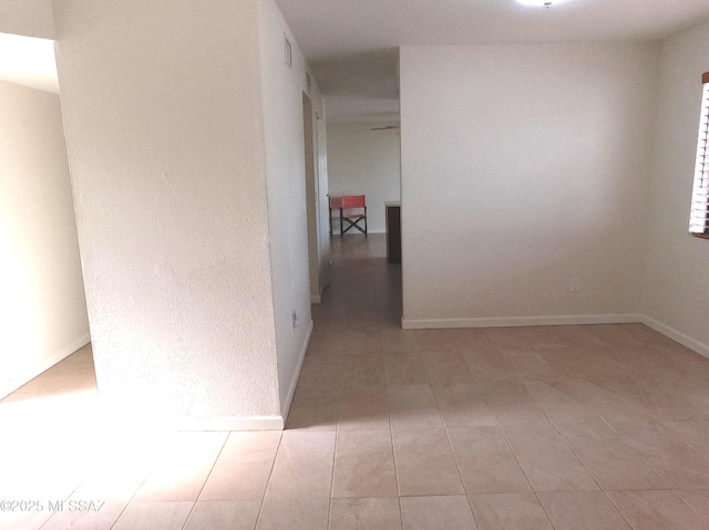 corridor featuring light tile patterned floors