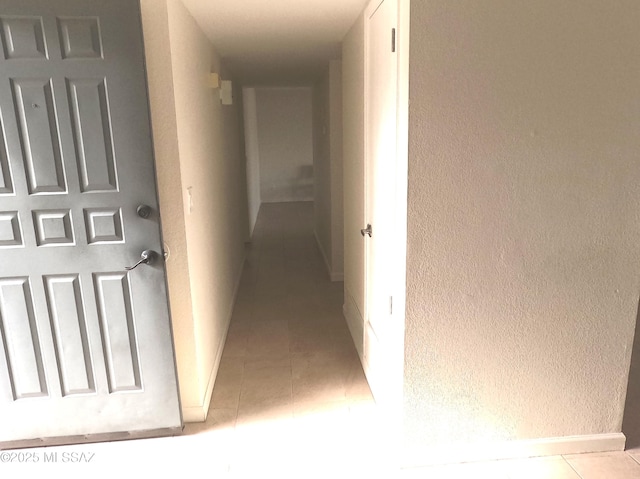 hallway with light tile patterned floors