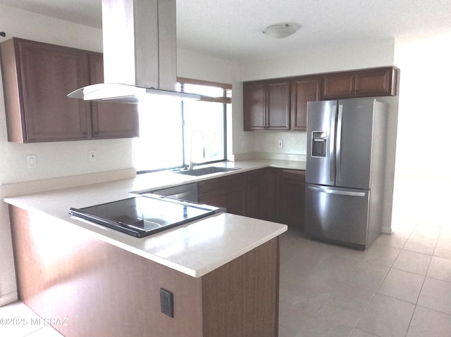 kitchen featuring sink, stainless steel fridge with ice dispenser, island range hood, cooktop, and kitchen peninsula