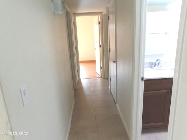 hall with light tile patterned flooring and sink