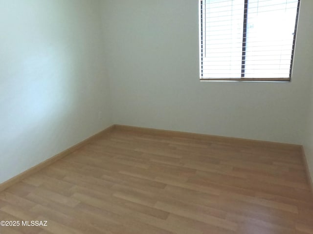 empty room with wood-type flooring