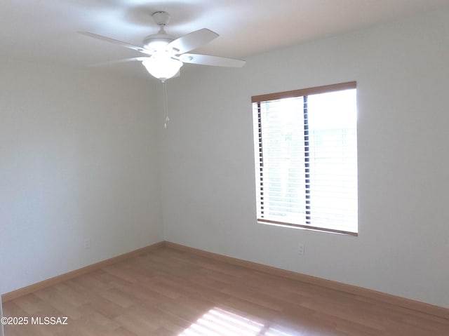 empty room featuring ceiling fan and light hardwood / wood-style floors