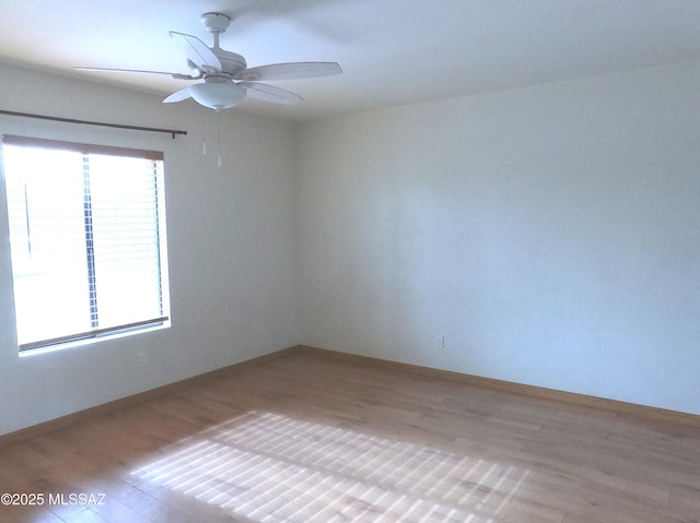 empty room with light hardwood / wood-style flooring and ceiling fan