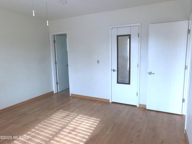 spare room with wood-type flooring