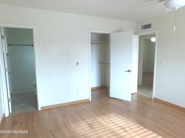 unfurnished bedroom with ensuite bath, ceiling fan, and light hardwood / wood-style flooring