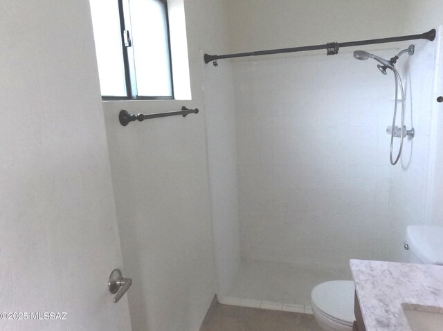 bathroom featuring walk in shower, tile patterned flooring, vanity, and toilet