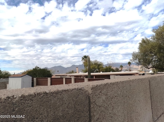 view of yard with a mountain view and a shed